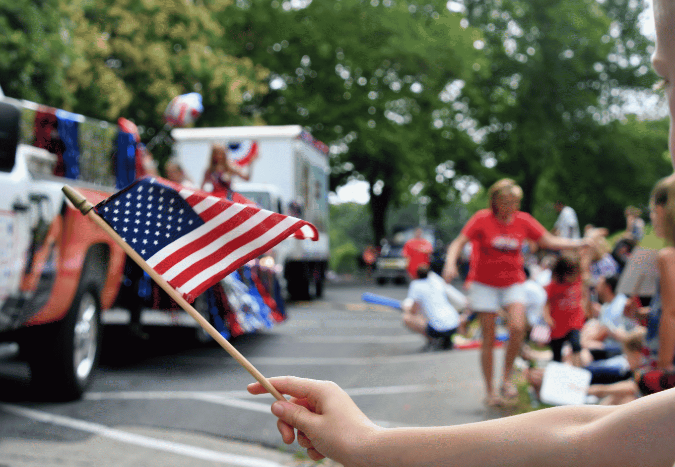 American Flag Held During Cheerful Patriotic Parade