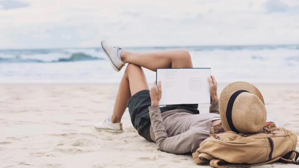 man reading on the beach
