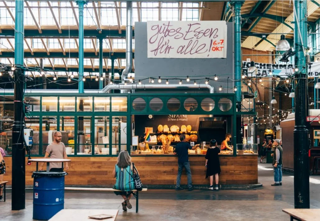 People buying food at the food stalls in Markthalle Neun