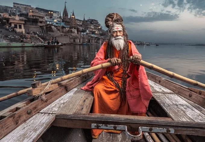 Portrait of sadhu Baba Nondo Somendrah, in a boat on the Ganges River in Varanasi, India.