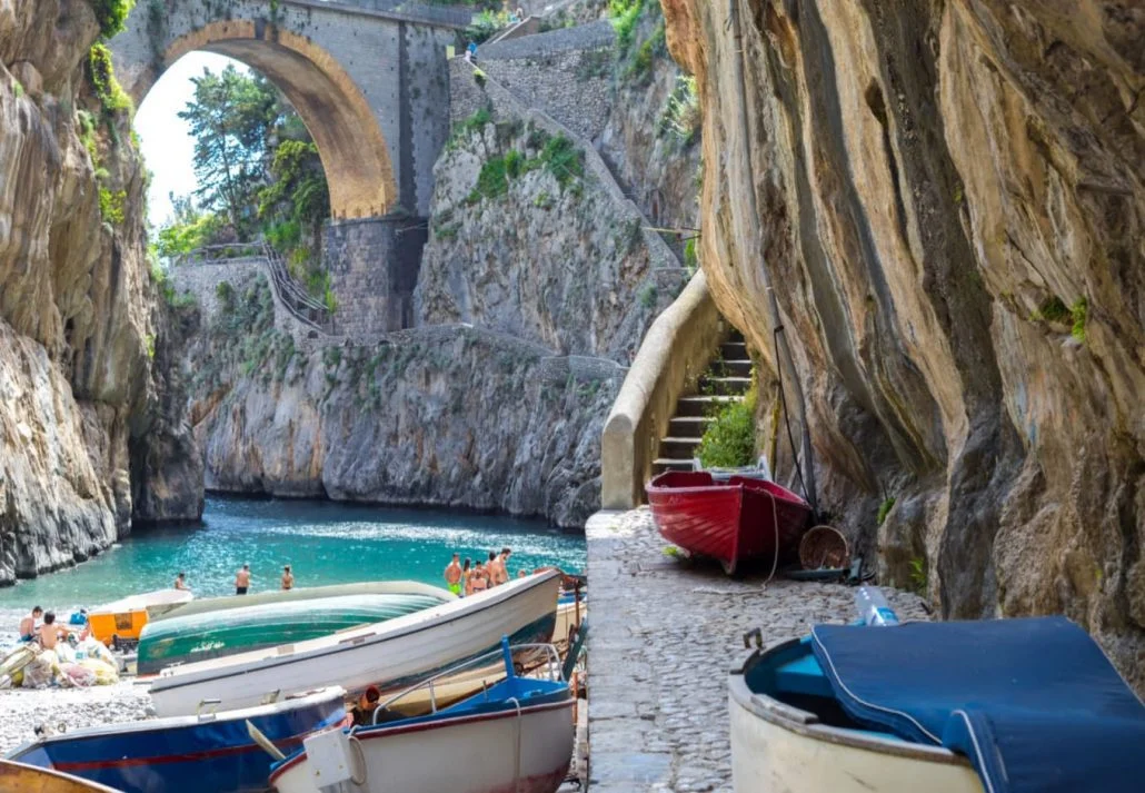 A beach with boats on the shore, Positano