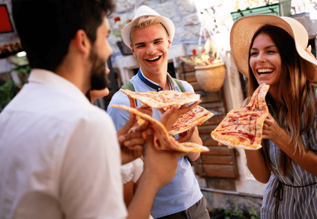  Happy people eating fast food at a festival in Italy 