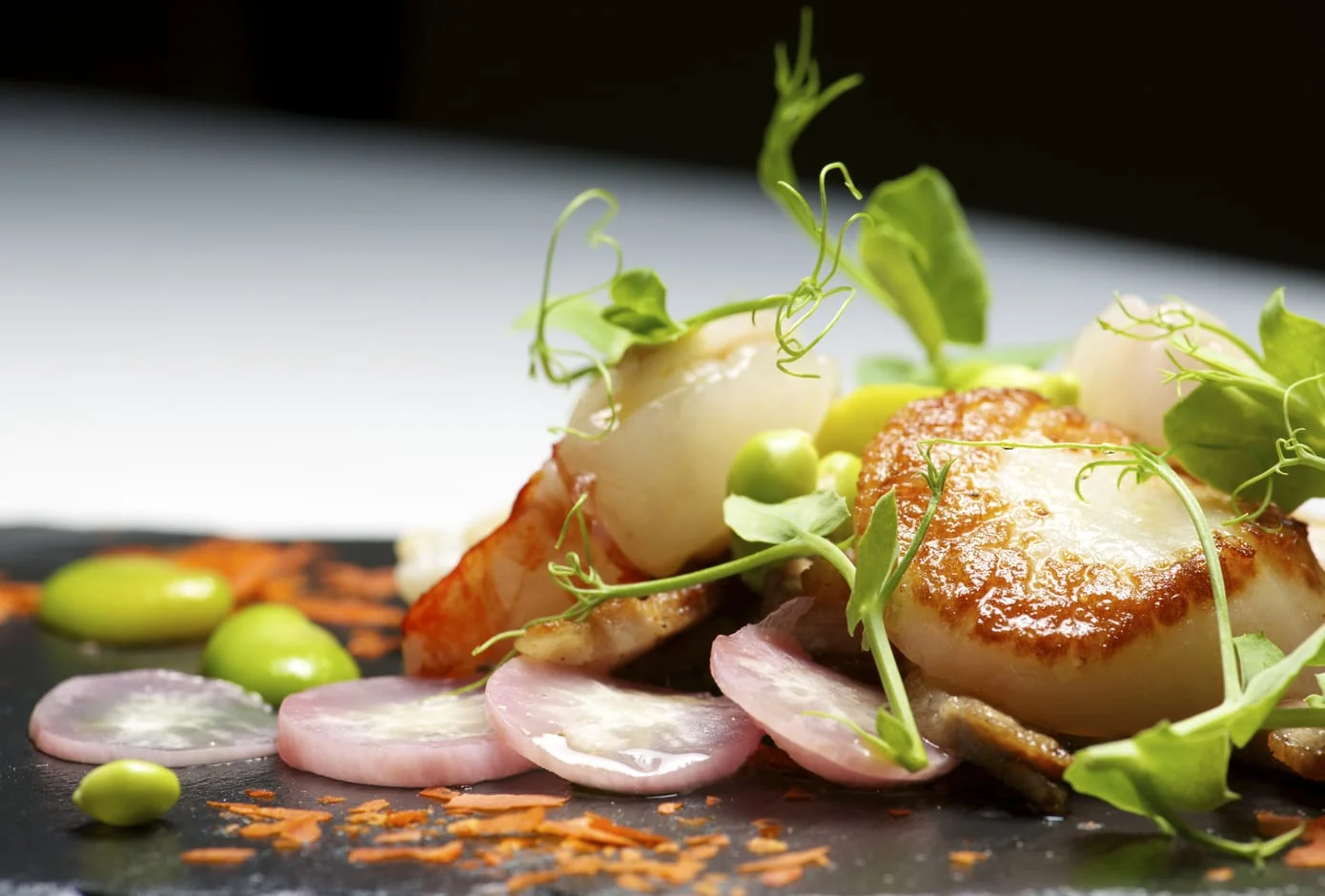 A gourmet dish made with pork, clams, and vegetables.