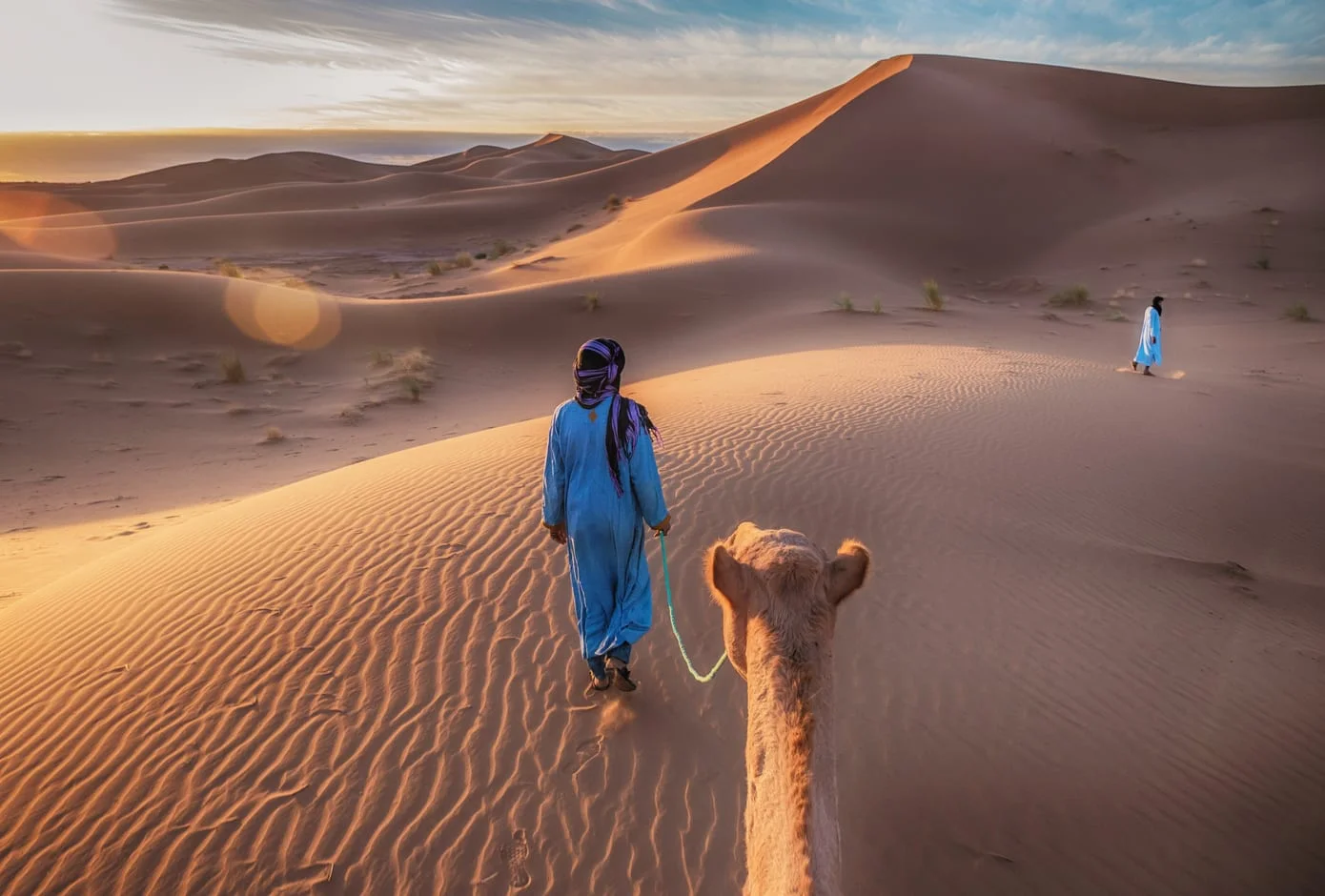 Nomad with camel in the Sahara Desert, Morocco.