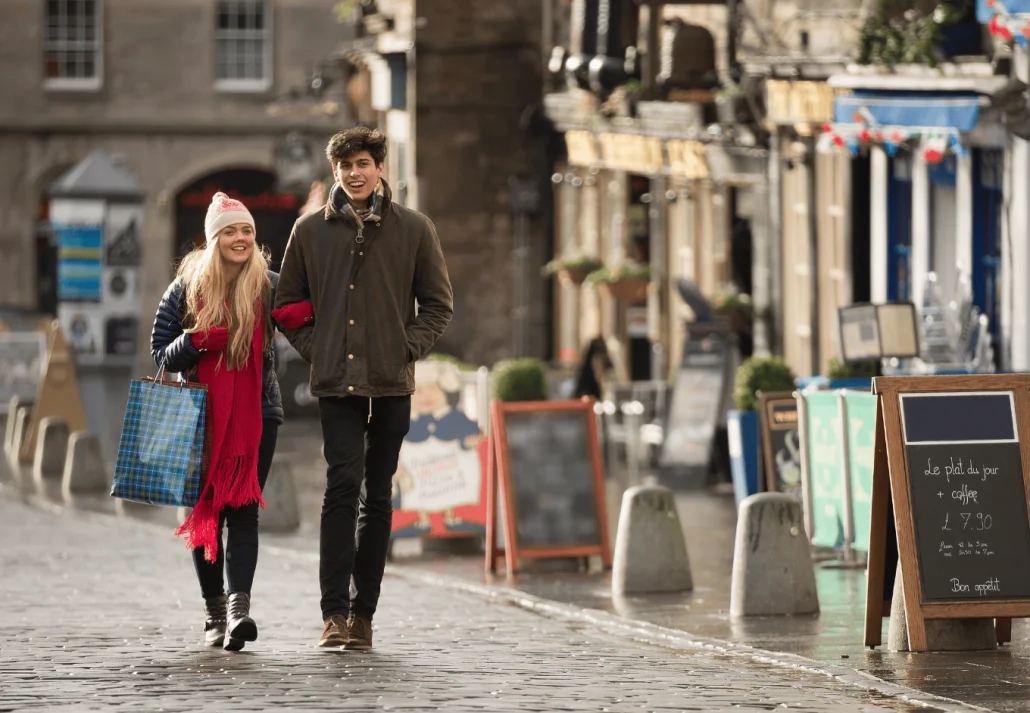 A young couple shop in the Grassmarket in Edinburgh, Scotland