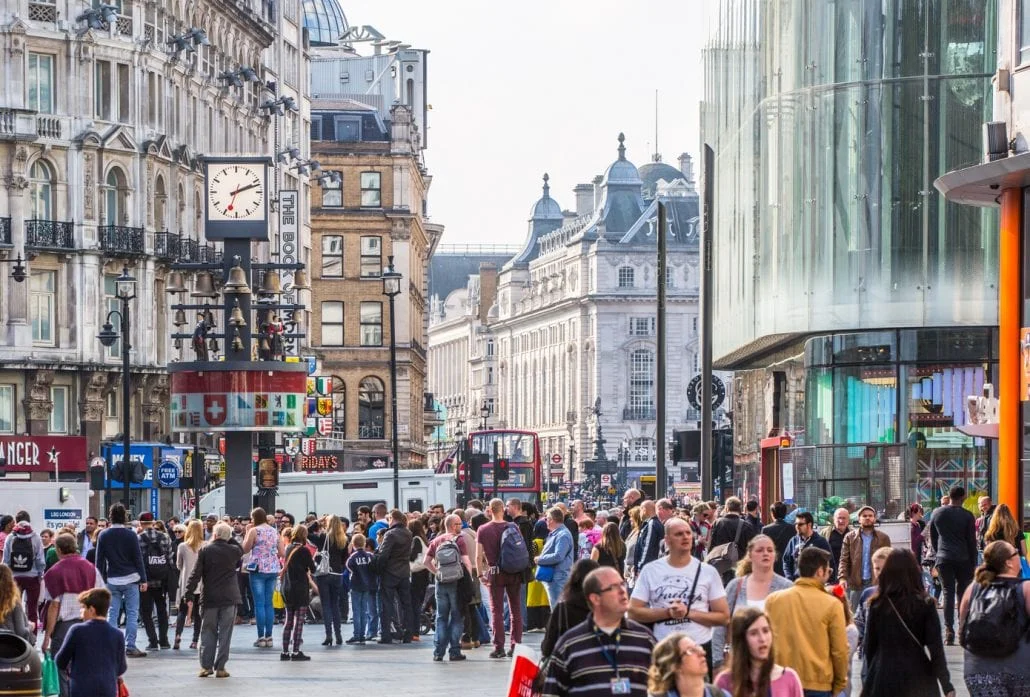 London Attractions - The buslting Leicester square filled with people, in London.