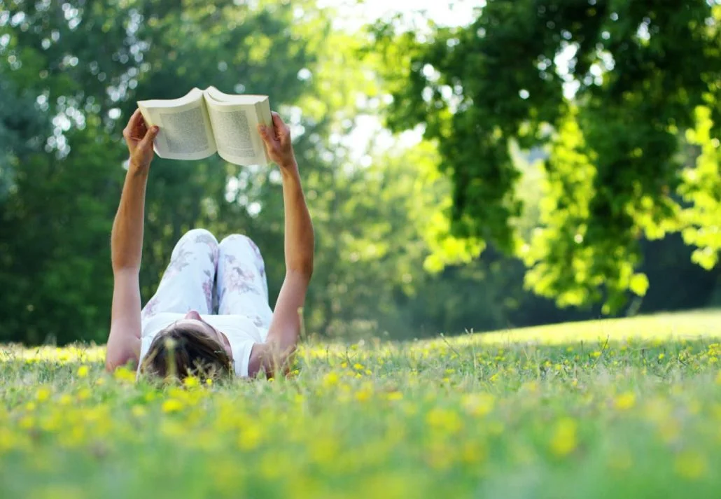 Parks in Cambridge - a woman reading a book in the park