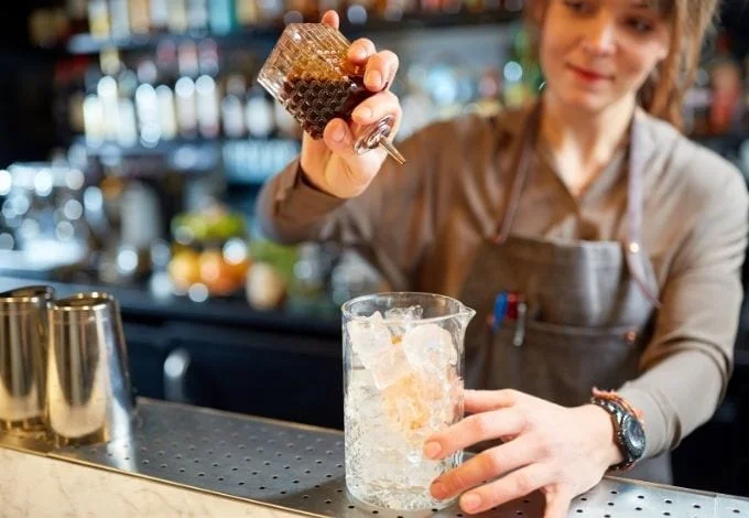A bartender making a drink.