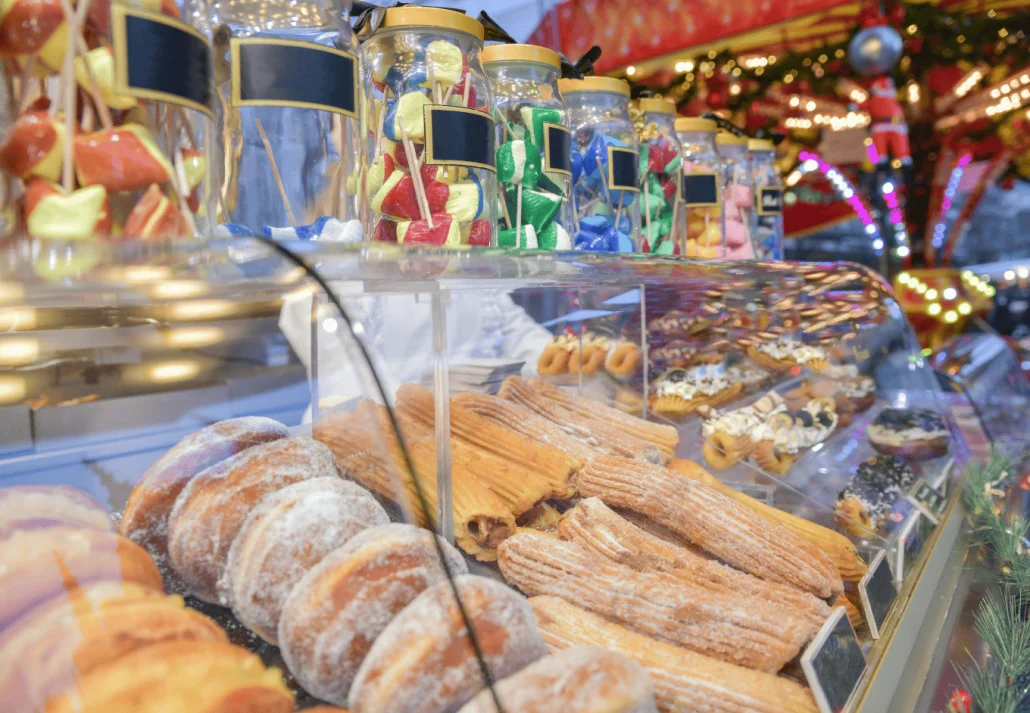 Lollipop donuts and cakes on a counter at the christmas market