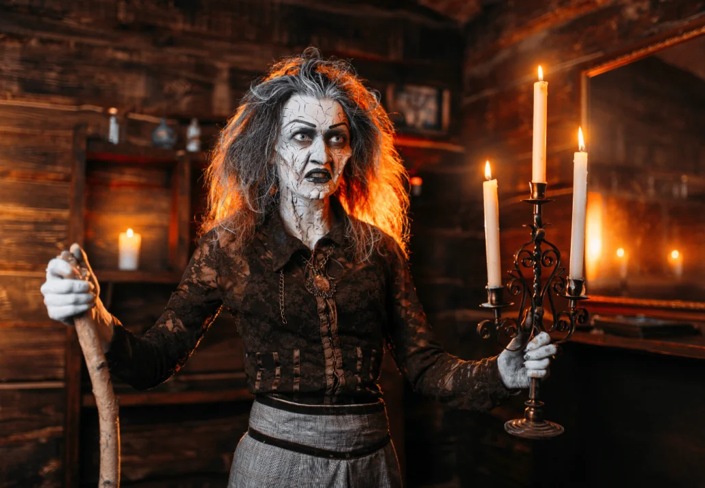 Scary witch with candlestick and cane reads spell