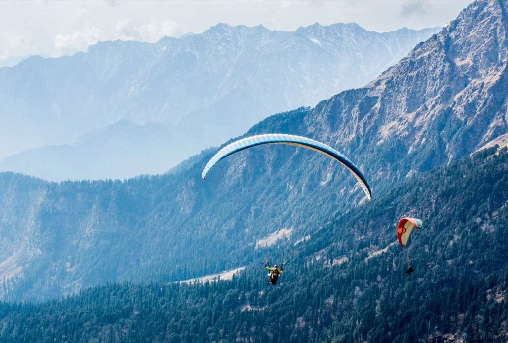 Two people paragliding in Solang Valley, in India.