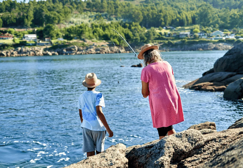 a-family-fishing-on-a-rock-by-the-water