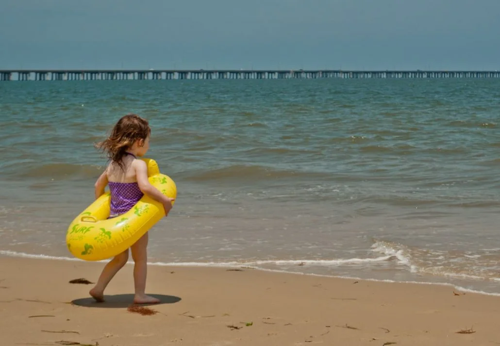 A little girl at the Chesapeake Bay Beach, Virginia Beach, Virginia.