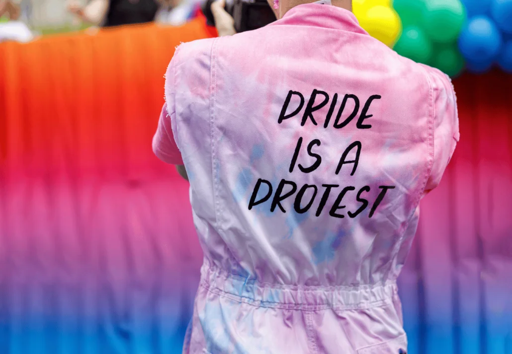 US cities to celebrate pride month Diverse people are walking on a gay pride parade on the city streets with flags